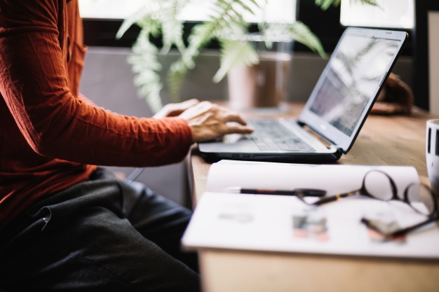 crop-man-working-with-laptop_23-2147689387